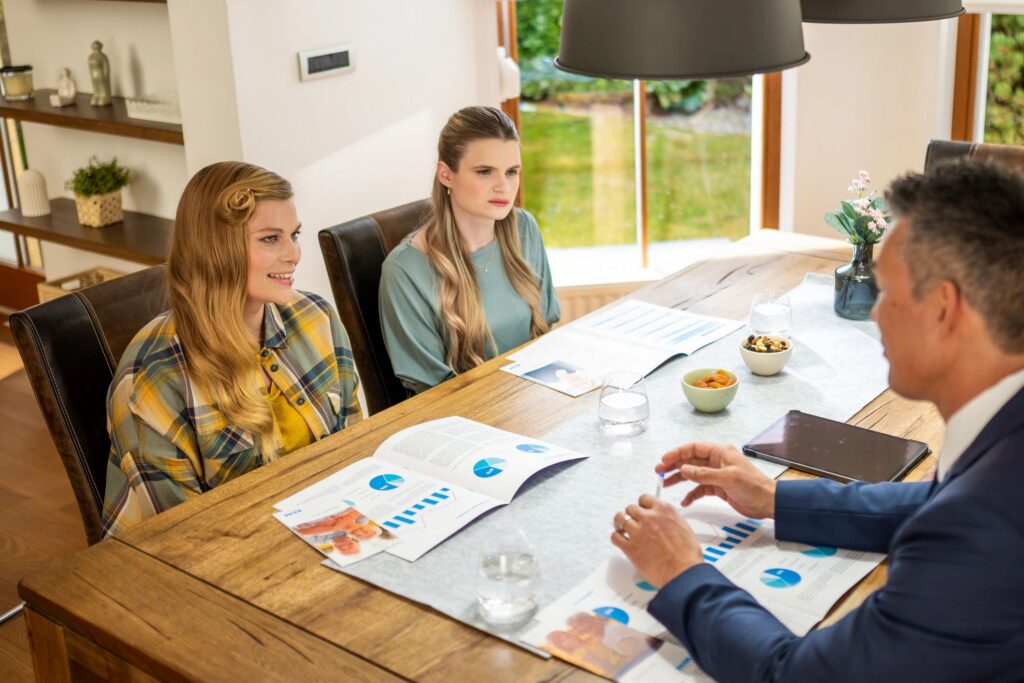 Real estate agent explaining leasing agreement to women